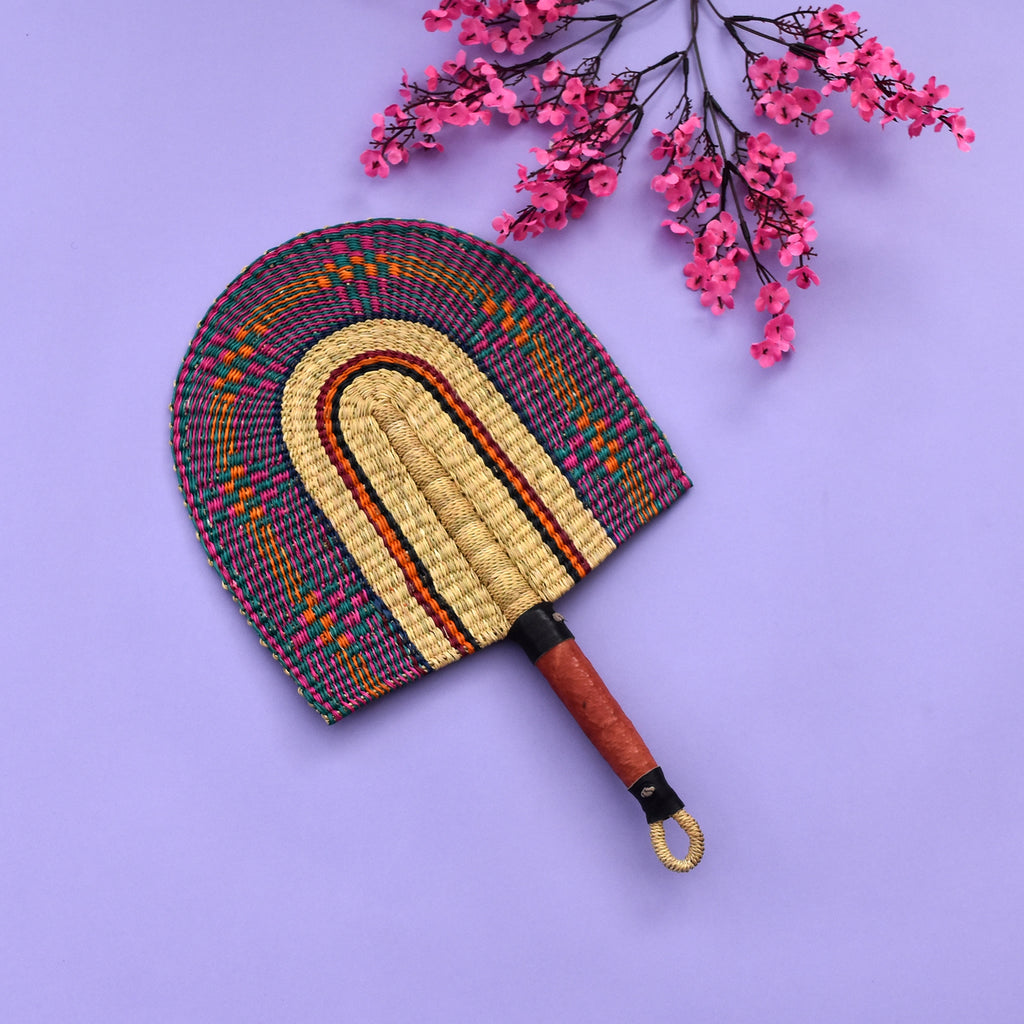 Durable handcrafted fans also known as Bolga fans, are woven from elephant grass and leather and dyed to give them a unique design or patterns. Each hand fan is a one-off piece so once it’s gone it’s gone.   The fans are perfect for keeping cool in the heat and for decorative purposes.   The handle has a loop at the end of the fan which makes it easy for hanging. You can equally mix and match a number of fans together as a piece of art display on the wall. You can also be creative in your own way.