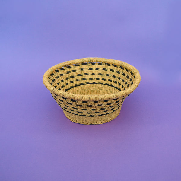 Multifunctional fruit basket for storing and decorating. This carefully hand-woven fruit baskets is made of Elephant straw. No basket is the same, each piece has been handcrafted in Bolga, Ghana. There may be some imperfections but that is due to the fact that they are handmade.  Not only is it straw basket or bowl great for storing your fruit and vegetables, It can be used for quiet a number of things including storing bits & bobs and decorating. A stylish way to keep clutter away in the house.