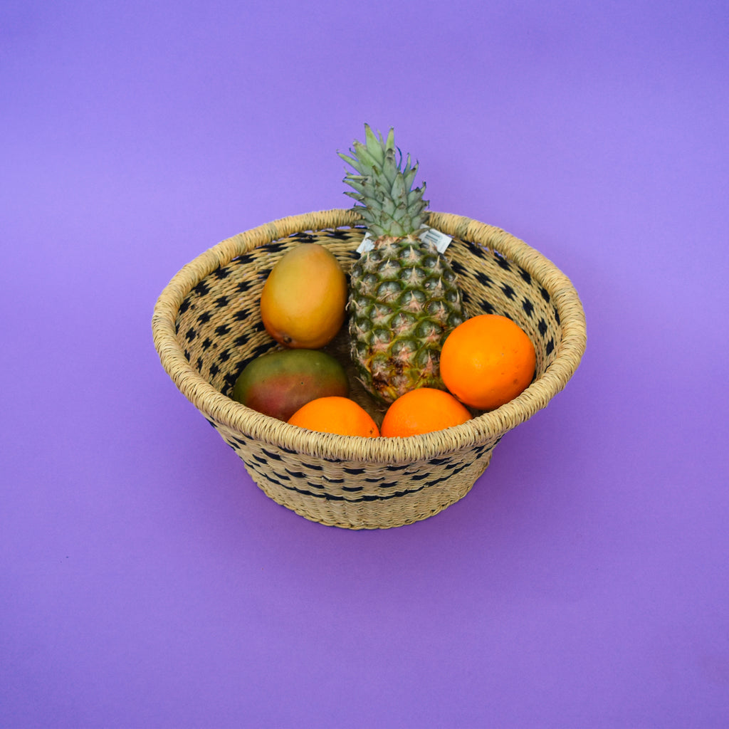 Multifunctional fruit basket for storing and decorating. This carefully hand-woven fruit baskets is made of Elephant straw. No basket is the same, each piece has been handcrafted in Bolga, Ghana. There may be some imperfections but that is due to the fact that they are handmade.  Not only is it straw basket or bowl great for storing your fruit and vegetables, It can be used for quiet a number of things including storing bits & bobs and decorating. A stylish way to keep clutter away in the house.