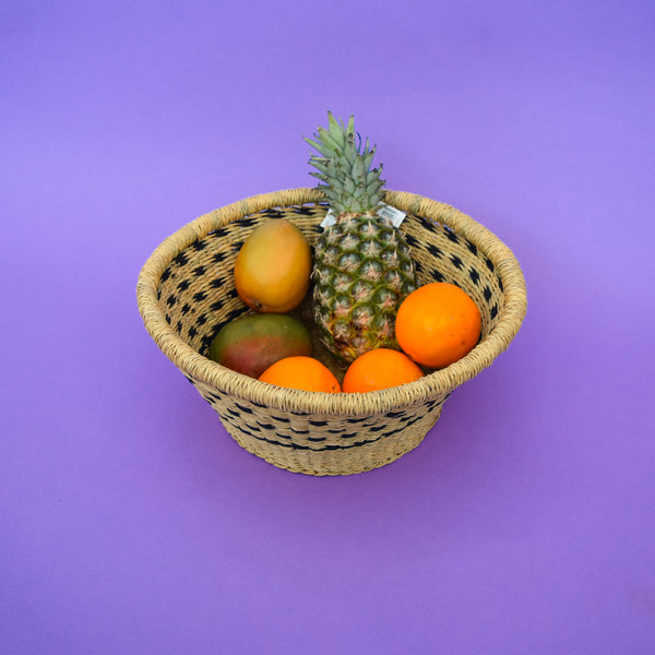 Multifunctional fruit basket for storing and decorating. This carefully hand-woven fruit baskets is made of Elephant straw. No basket is the same, each piece has been handcrafted in Bolga, Ghana. There may be some imperfections but that is due to the fact that they are handmade.  Not only is it straw basket or bowl great for storing your fruit and vegetables, It can be used for quiet a number of things including storing bits & bobs and decorating. A stylish way to keep clutter away in the house.